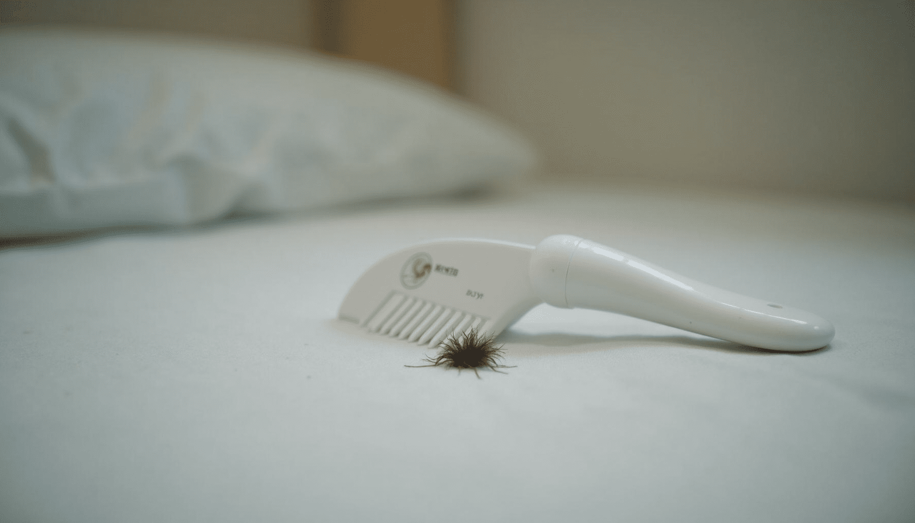 A fine-toothed lice comb resting on a child's pillow, hinting at the need for effective lice treatment kits.