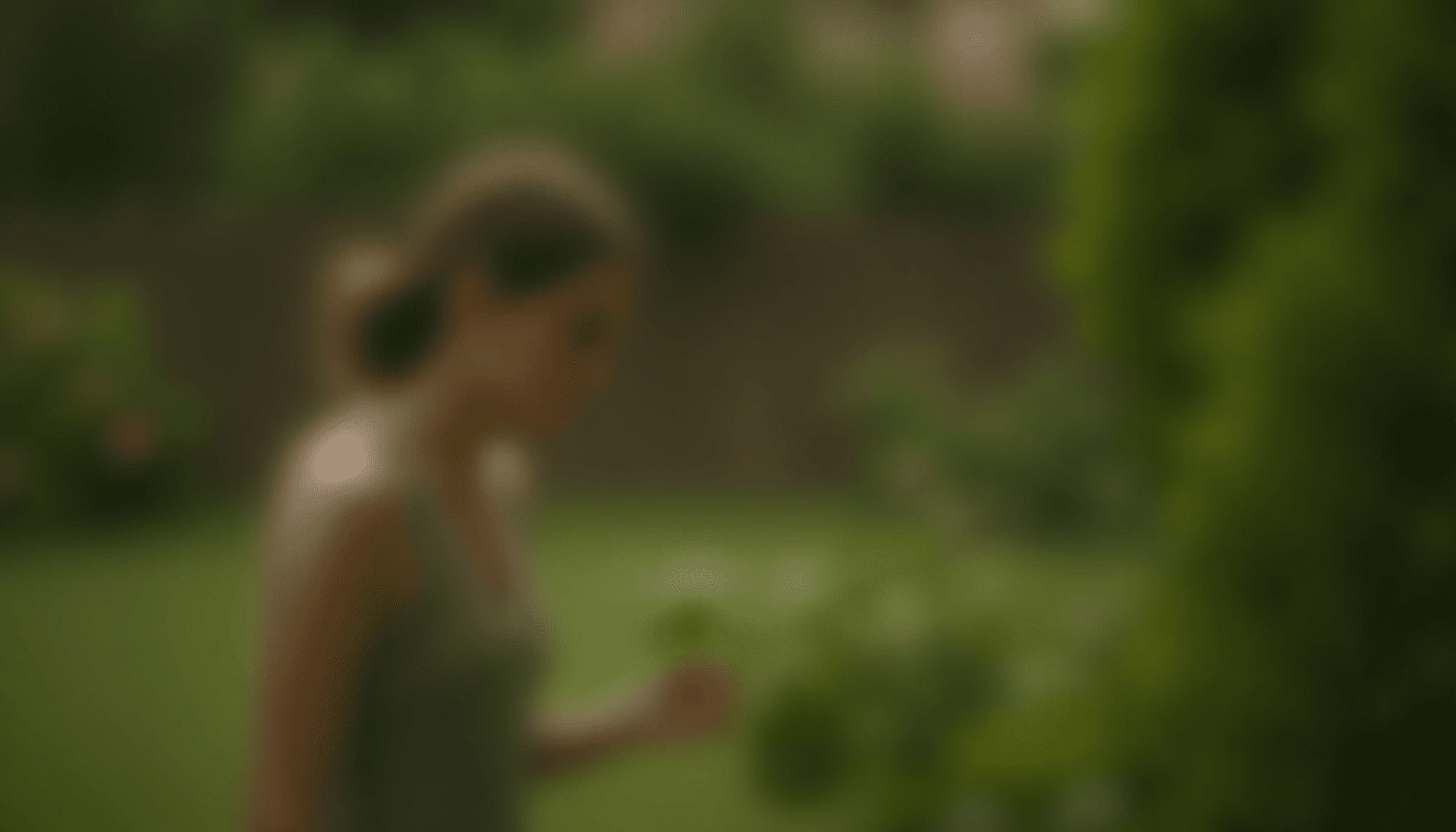 Person in a summer garden, observing plants and listening for insect sounds, capturing the essence of summer insect sounds.