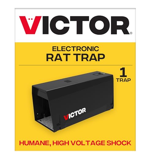 Indoor electronic rat trap placed against a cabinet kickplate