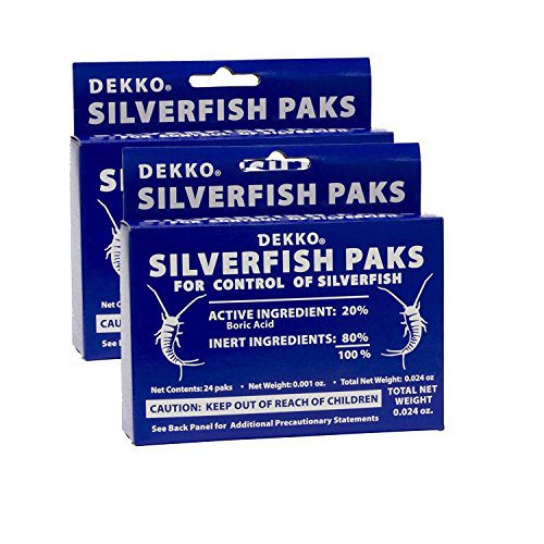 Boric-acid silverfish bait paks tucked into a crack behind a baseboard